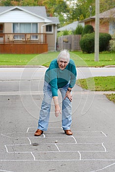 Senior woman playing hopscotch