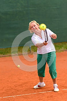 Senior woman playing tennis