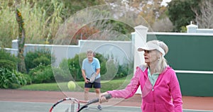 Senior woman playing tennis in tennis court 4k