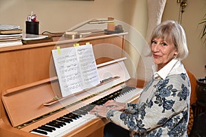 Senior woman plays piano