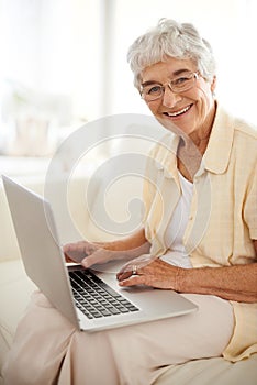 Senior woman, portrait and laptop for blog in home, smile and happy with website on internet. Elderly person, living