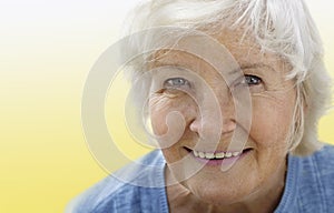 Senior woman portrait on yellow