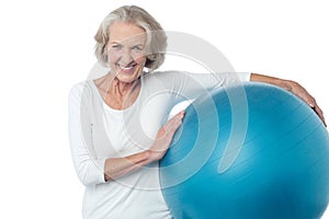 Senior woman posing with exercise ball