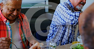 Senior woman pouring juice into glass to her friend 4k