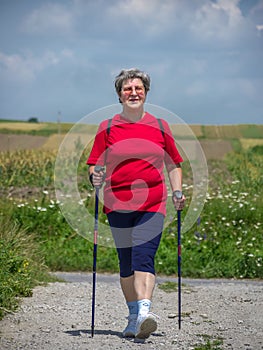 Senior woman practicing Nordic walking