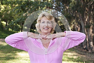 Senior woman practicing posture in park