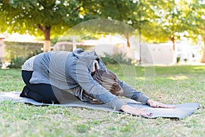 Senior Woman Practicing Yoga At Park