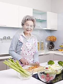 Senior woman preparing meal in kitchen