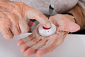 Senior Woman Pressing Alarm Button