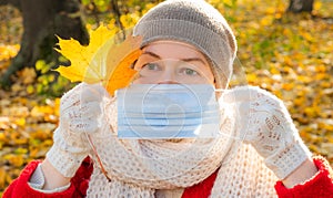 Senior woman protective medical mask autumn park age middle 50 plus red orange funny covid 19