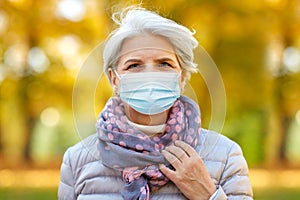 Senior woman in protective medical mask at park