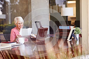 Senior Woman Putting Letter Into Keepsake Box