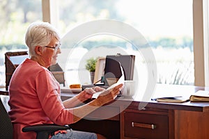 Senior Woman Putting Letter Into Keepsake Box