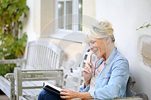 Senior woman reading book enjoying