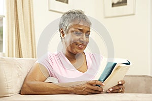 Senior Woman Reading Book At Home