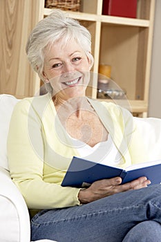 Senior Woman Reading Book At Home