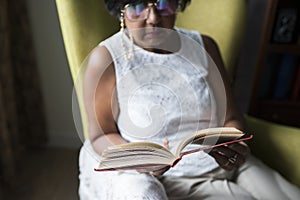 Senior woman reading book in the room