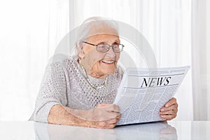 Senior Woman Reading Newspaper