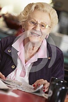 Senior woman reading newspaper