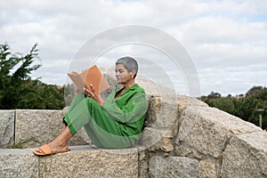 Senior woman reading in park