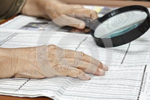 Senior woman reading stock listings