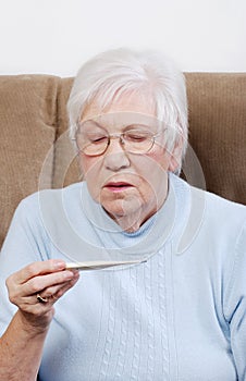 Senior woman reading a thermometer