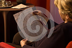 Senior woman reading yellowed letter