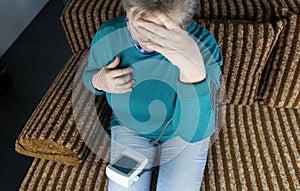 Senior woman reads instructions for medicines. Woman looks at the list and composition of the drug. Concept home self-medication