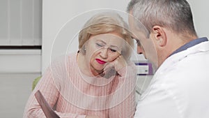 Senior woman receiving bad news at medical appointment with her doctor
