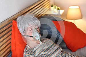 Senior woman receiving breathing treatment