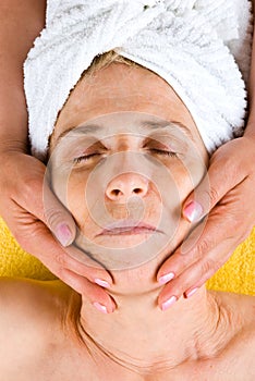 Senior woman receiving a facial massage