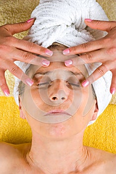 Senior woman receiving facial massage