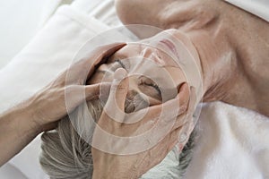 Senior Woman Receiving Head Massage At Spa