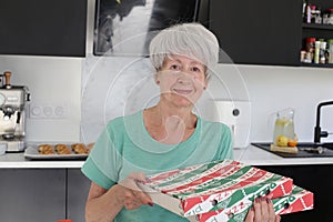 Senior woman receiving pizza delivery