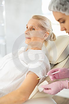 Senior woman receiving vaccine.