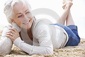 Senior Woman Relaxing On Beach