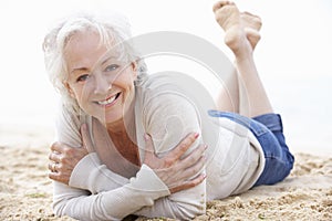 Senior Woman Relaxing On Beach