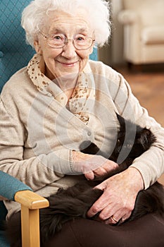 Senior Woman Relaxing In Chair At Home