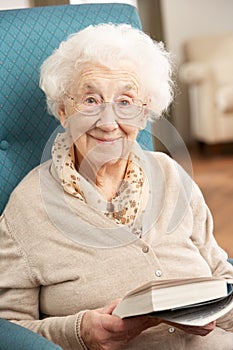 Senior Woman Relaxing In Chair At Home