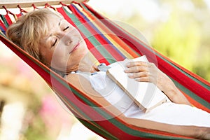 Senior Woman Relaxing In Hammock