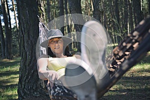 Senior Woman Relaxing In Hammock.