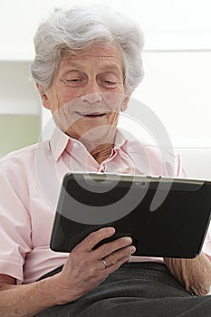 Senior woman relaxing with her laptop