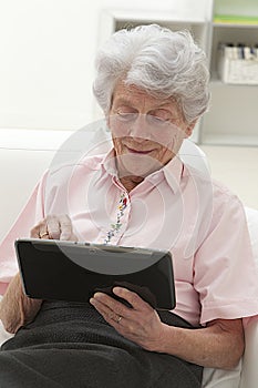 Senior woman relaxing with her laptop