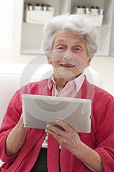 Senior woman relaxing with her laptop