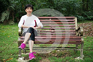 Senior woman relaxing on park bench