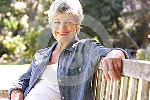 Senior Woman Relaxing On Park Bench