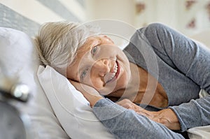 Senior woman resting on bed