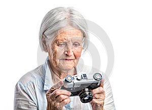 Senior woman with retro camera.