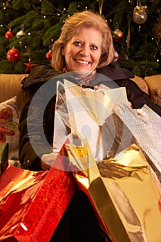 Senior Woman Returning After Christmas Shopping Tr