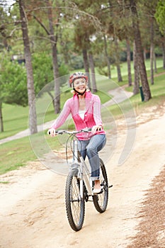 Senior woman riding bicycle in park